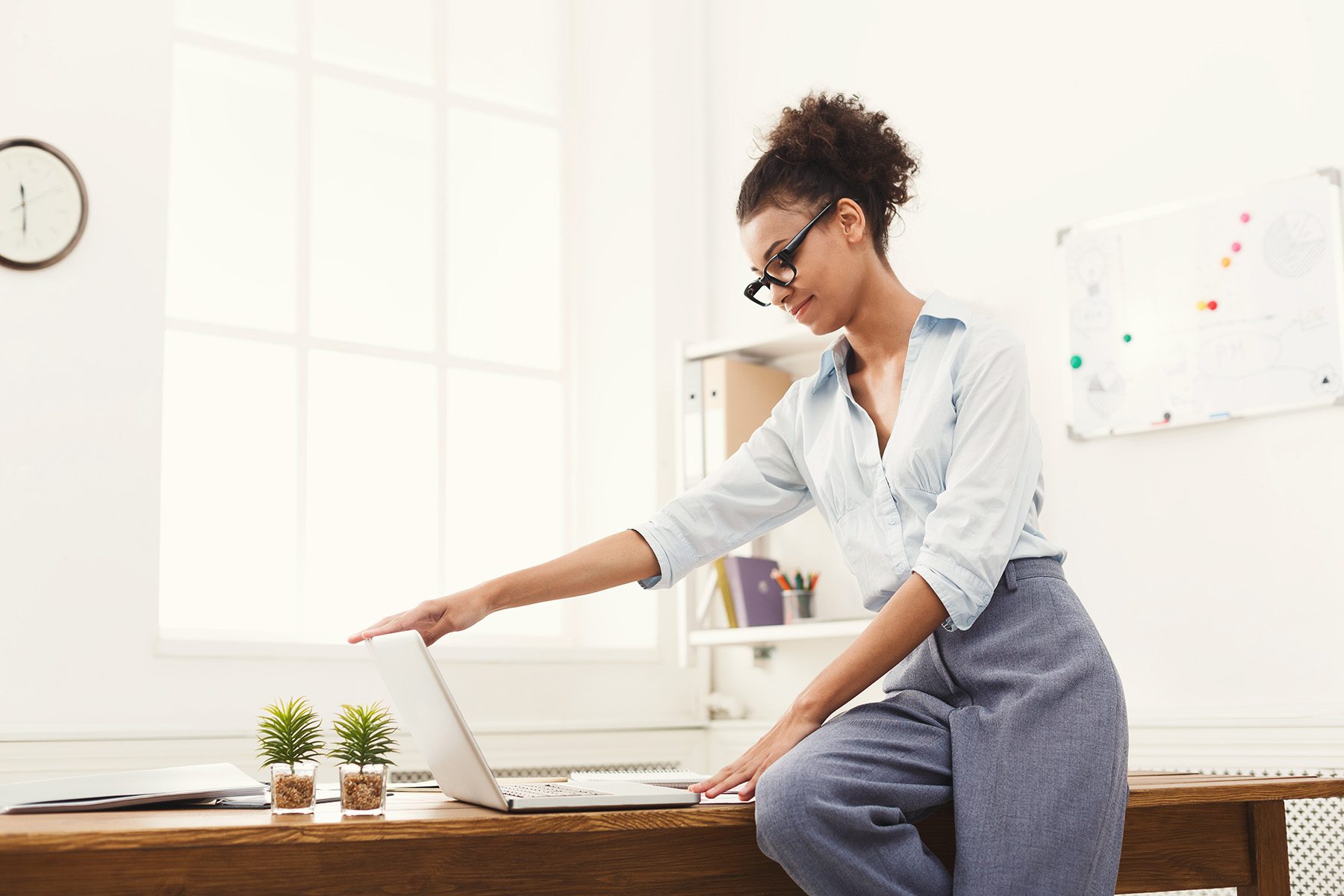 Business woman opening laptop at office